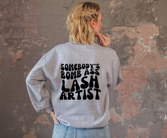 SWEATSHIRT or T-SHIRT-  SOMEBODY'S BOMB ASS LASH ARTIST ( front and back )